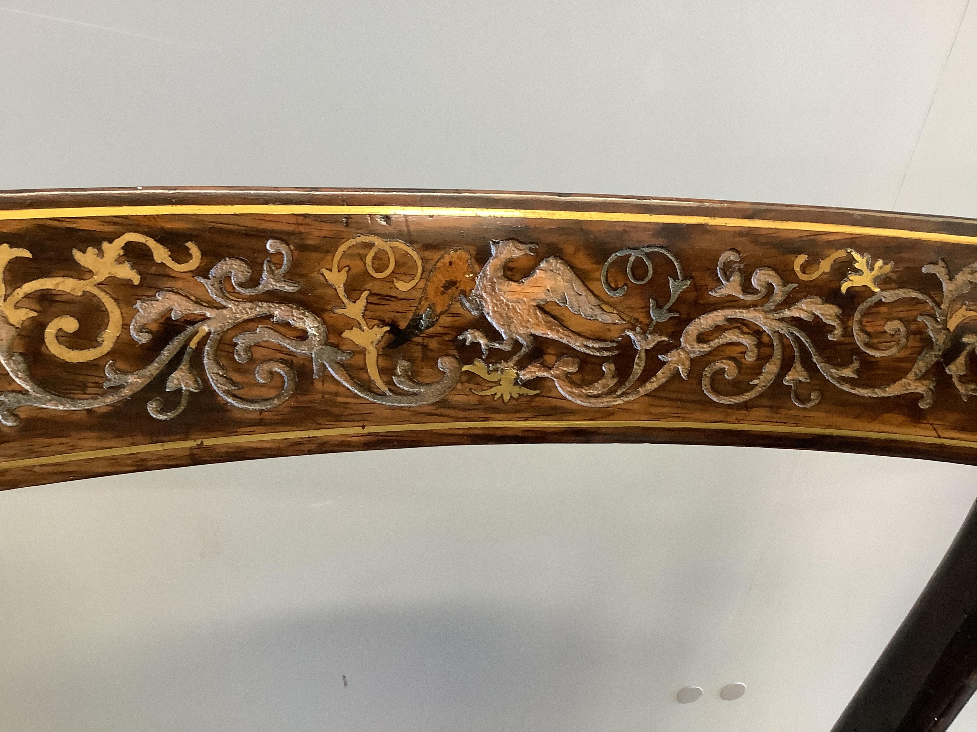 A set of six Regency rosewood and simulated rosewood dining chairs, the top rails inlaid with cut brass decoration, caned seats with slip-in cushions, on sabre legs. Condition - poor
